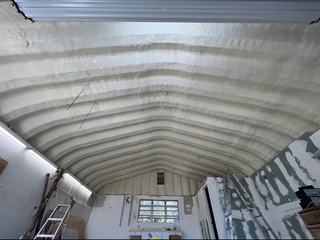 Spray polyurethane foam applied to the underside of a metal roof deck in Sodus